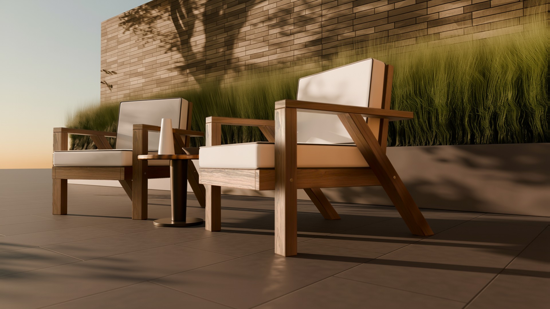 A pair of teak angled-leg lounge chairs on a patio, seen low from the front right in golden light with leaf shadows