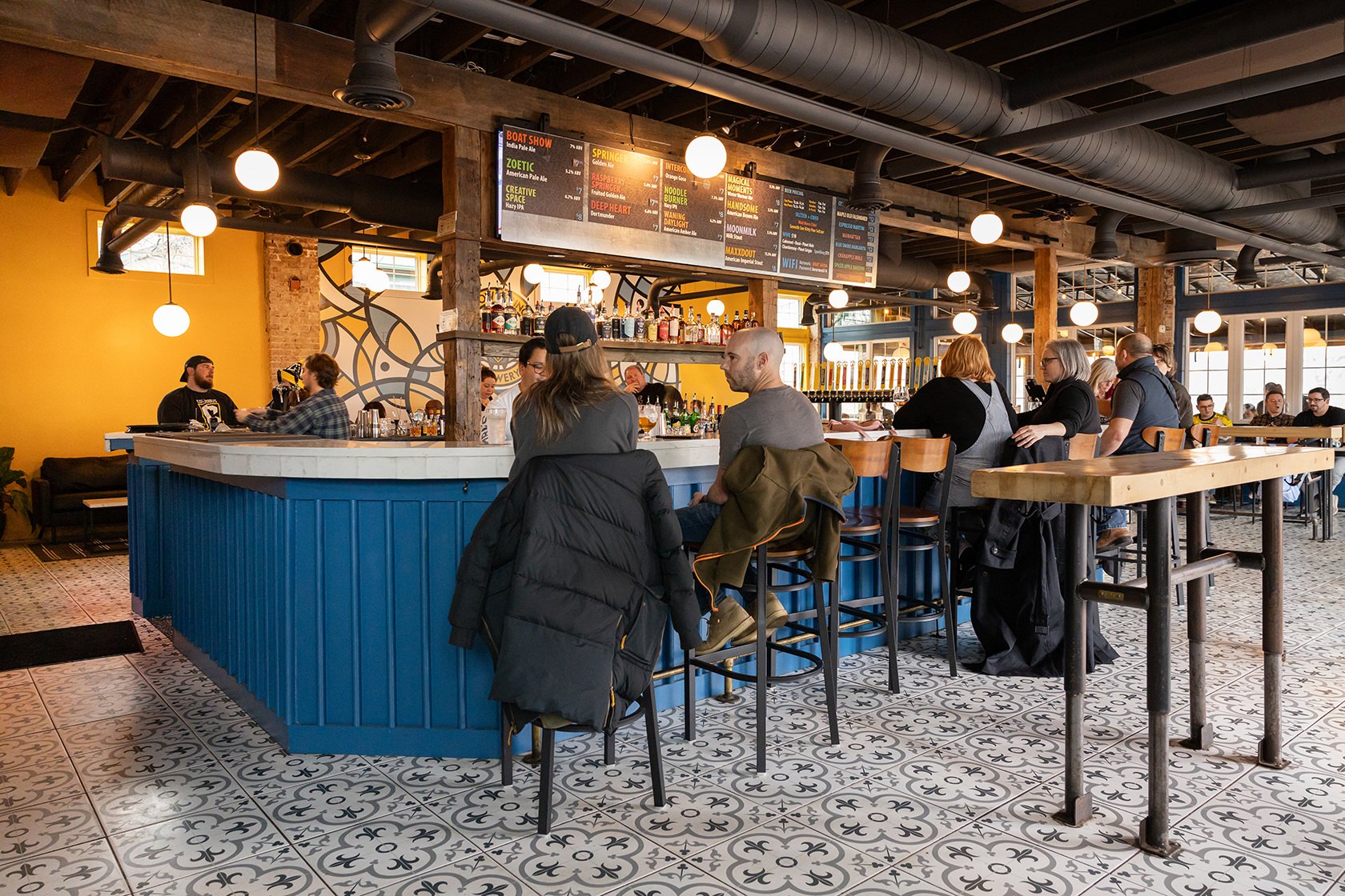 Guests along the blue bar under the menu boards