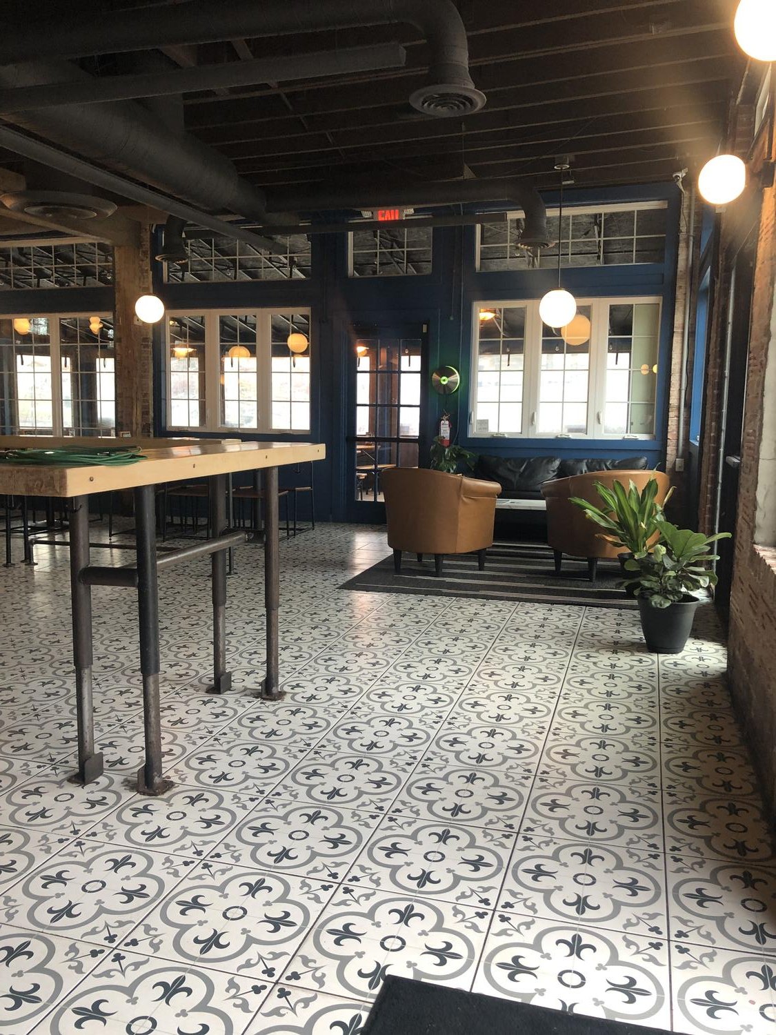 Lounge seating by the windows on the patterned tile floor