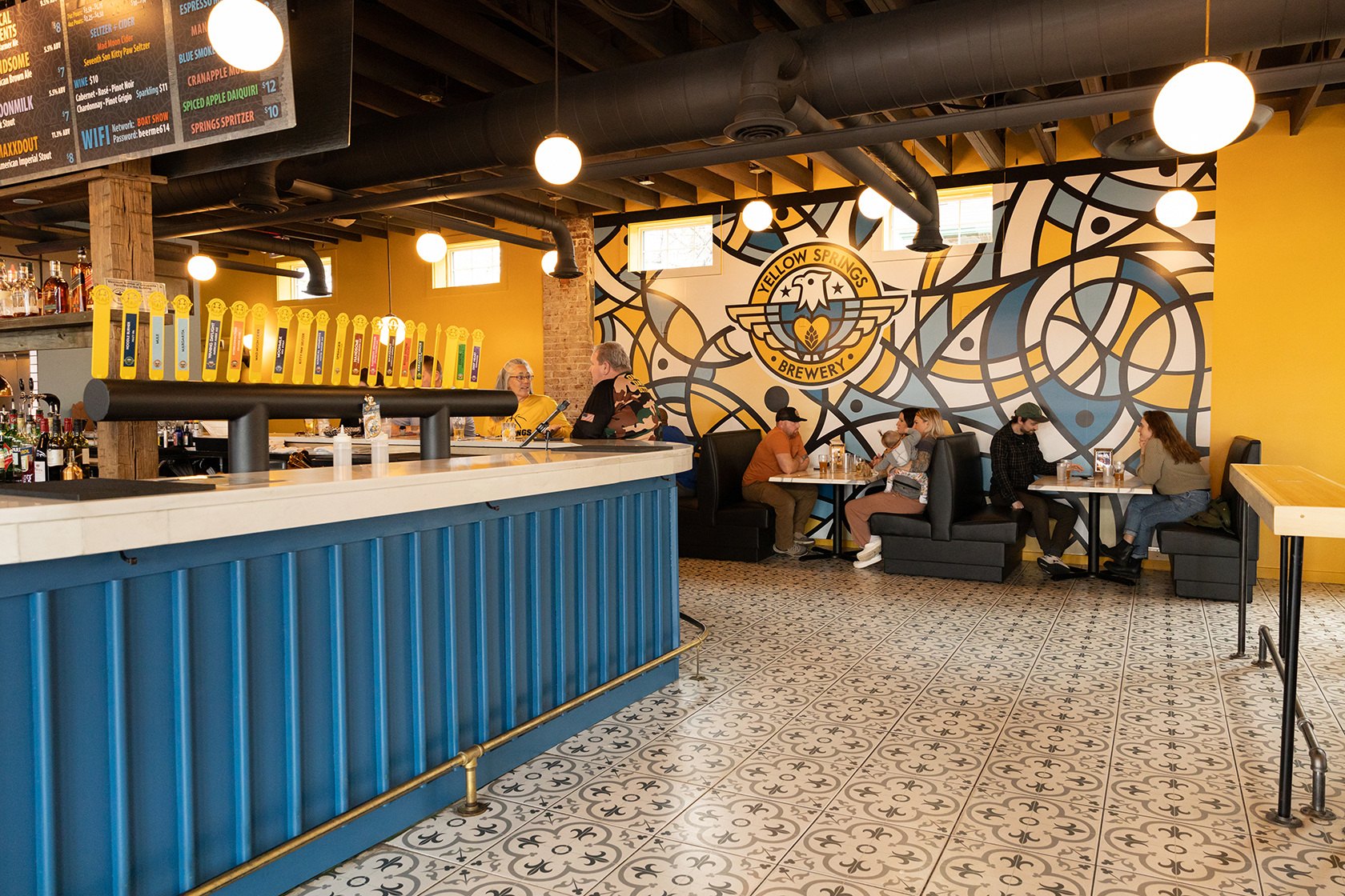 The blue bar with the brewery mural on the yellow back wall