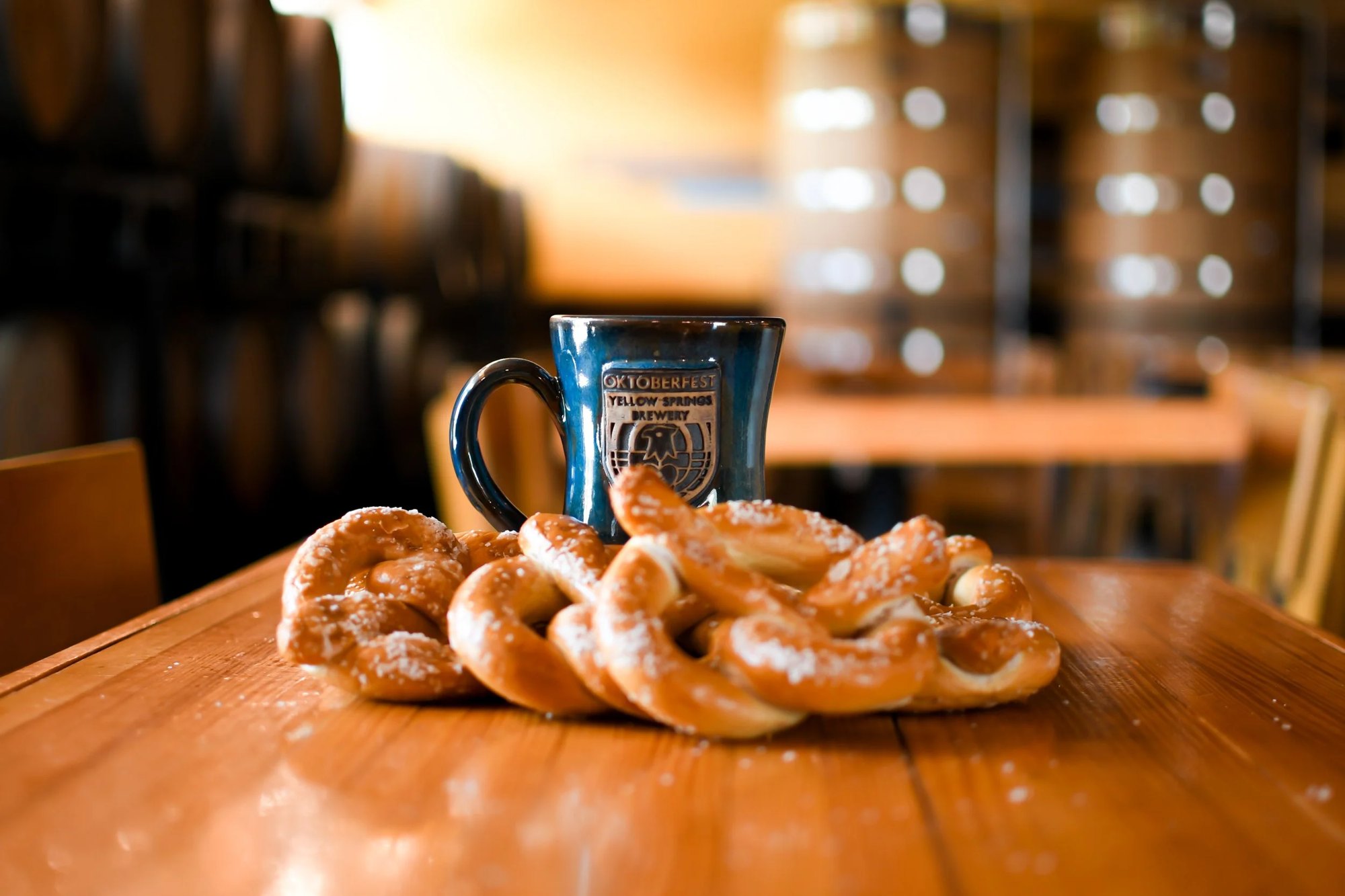 A pottery stein behind a pile of Smales soft pretzels