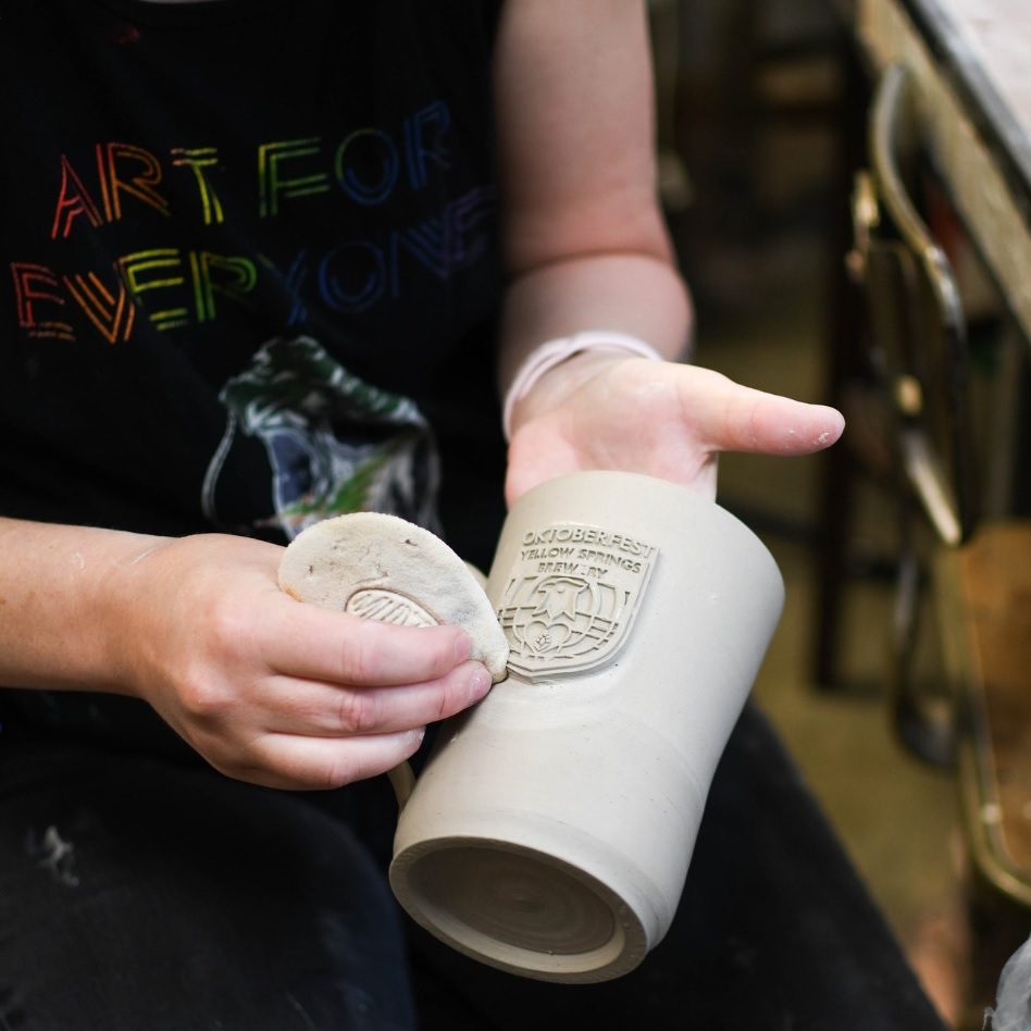 Meg Smallwood holds a special-edition stein stamped with the brewery logo